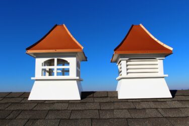 white composite cupolas with copper colored roof