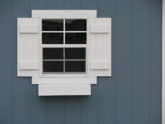 storage buildings window with shutters and flower box